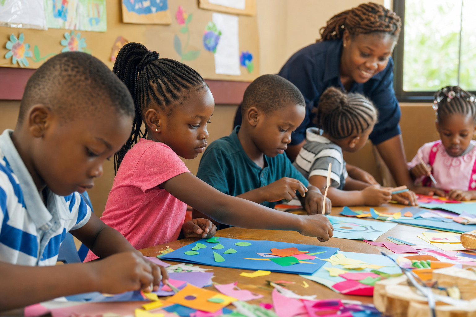 Nigerian children making colourful paper collages together at an art table.